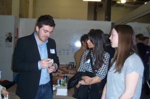 IMC students Dawn Gollen and Rushmi Deol talk with one of the event organizers Dave Inglis of the Laurier Launch Pad.